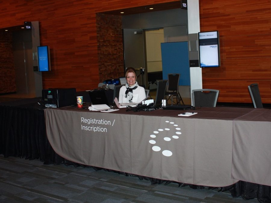 Photo of a CICS employee at the registration desk